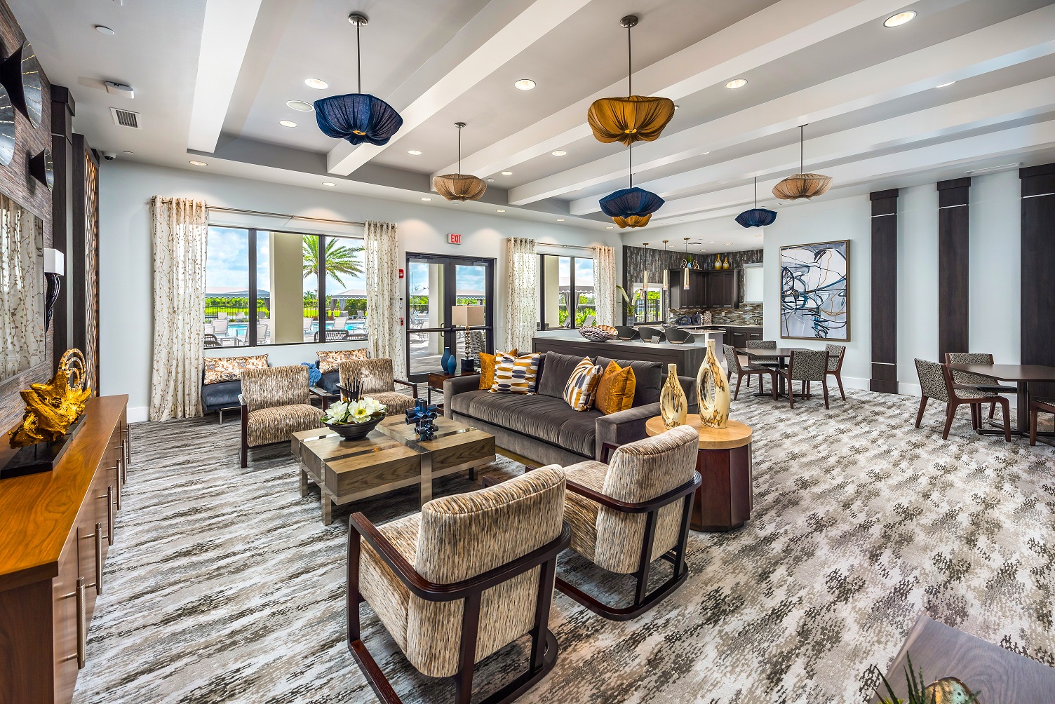 Dakota clubhouse lounge with warm pendant lighting and lakeside view